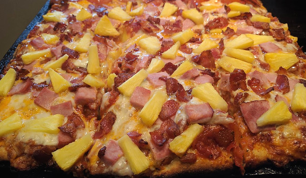 Hawaiian pizza with bacon, ham and pineapple
