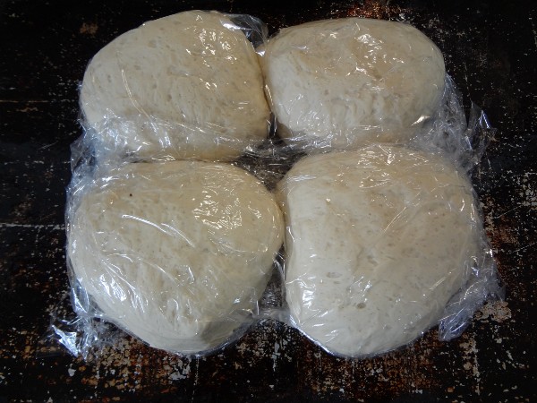 Dough quartered, shaped into balls and wrapped in cellophane
