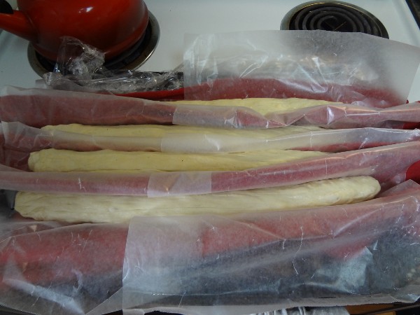 Dough shaped into baguettes and folded into a makeshift couche