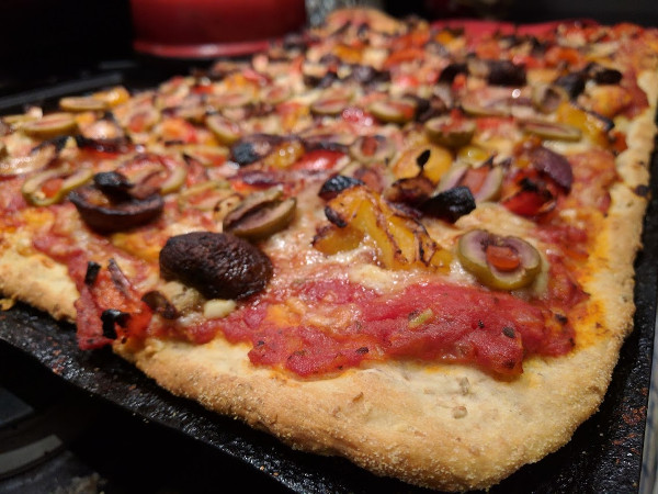 Pizza with olives and roasted peppers, mushrooms and onions
